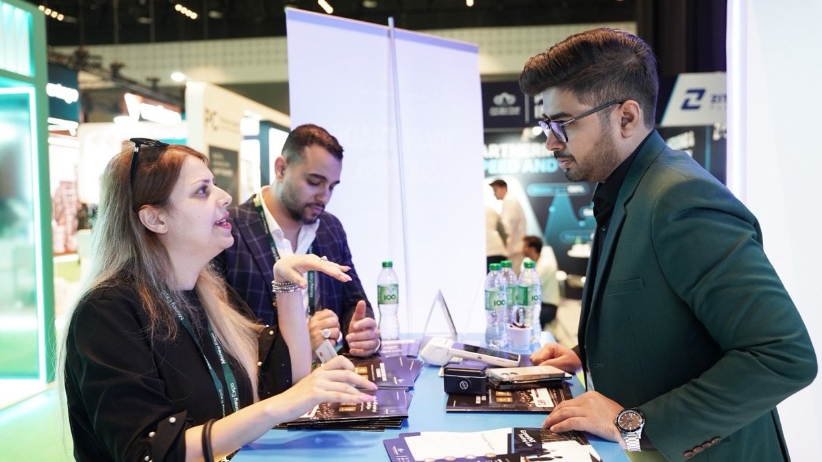 A GrowthX team member walking visitors through the programs at the stand