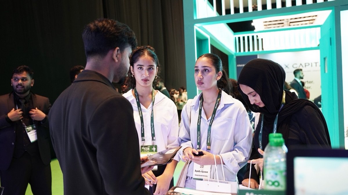 Visitors asking questions at the GrowthX Money Expo stand